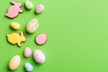 Happy Easter concept. Preparation for holiday. Easter eggs on colored background. flat lay top view copy space banner.