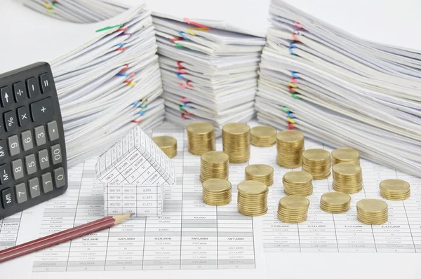 House and brown pencil with pile of gold coins — Stock Photo, Image