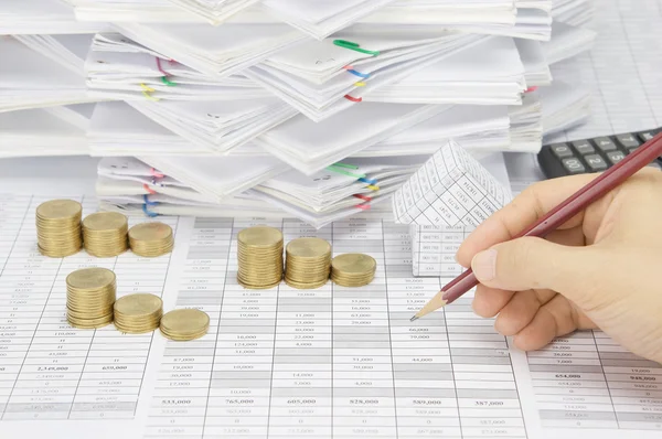 Man is auditing account by pencil with step gold coins — Stock Photo, Image