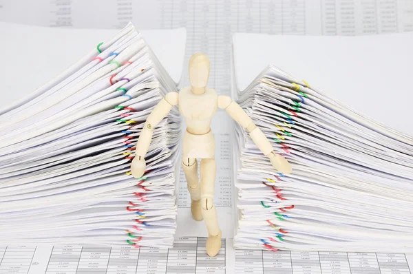 Wooden dummy try to escape from dual pile overload document — Stock Photo, Image