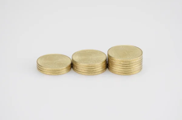 Close up step pile of gold coins isolated on white background — Stock Photo, Image