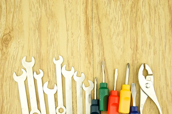 Wrench and small colorful screwdriver — Stock Photo, Image