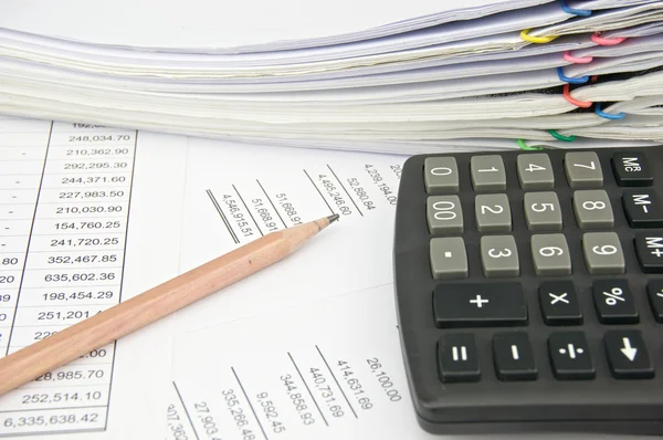 Calculator and pencil on statement with balance sheet — Stock Photo, Image