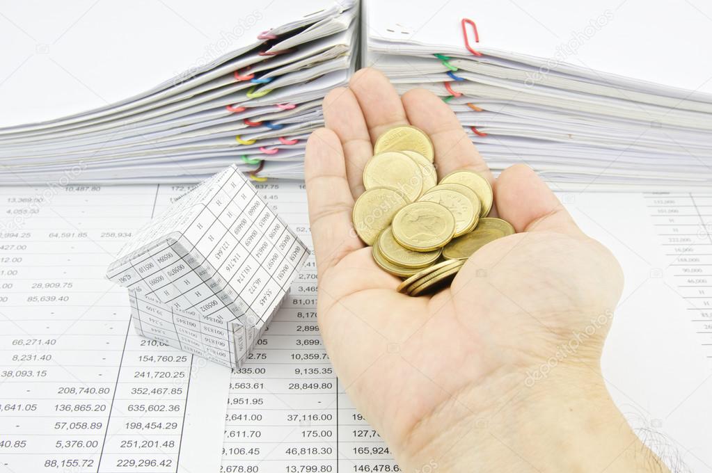 Man holding gold coins for buy house