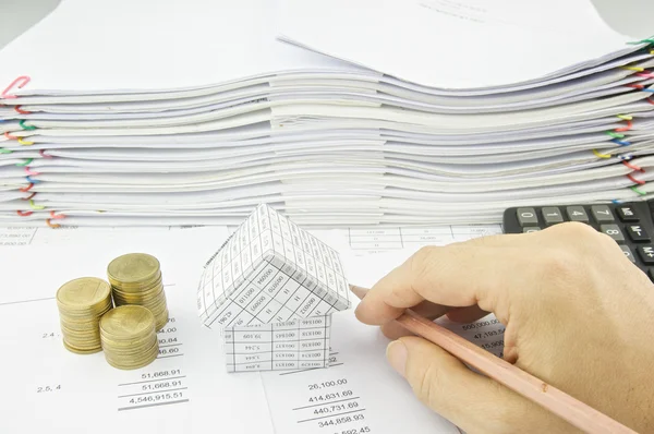 Man holding pencil near house and gold coin — Stock Photo, Image