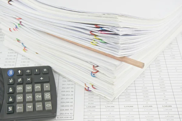 Brown pencil put in stack paperwork with calculator — Stock Photo, Image