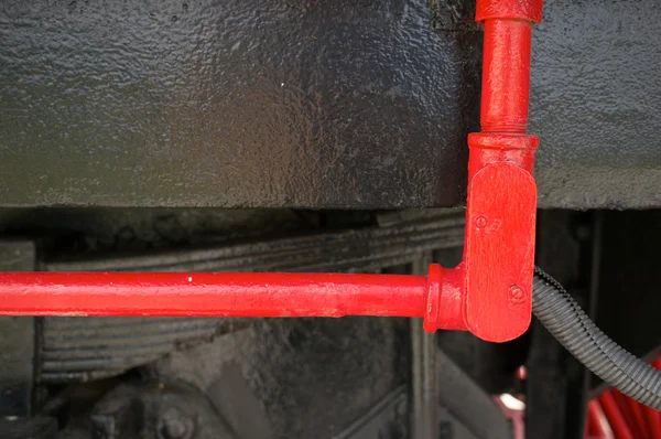 Red steel tube for oil on black train — Stock Photo, Image