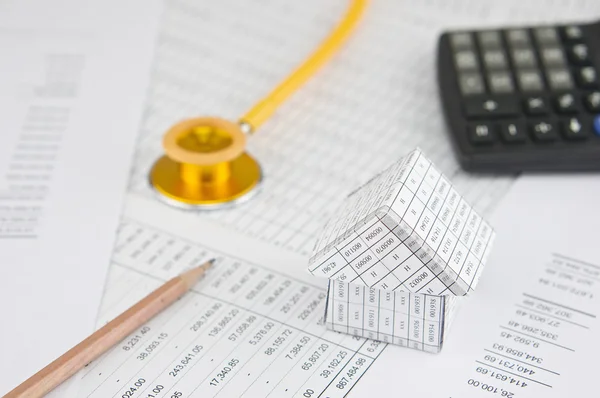 Close up house with gold stethoscope and pencil — Stock Photo, Image