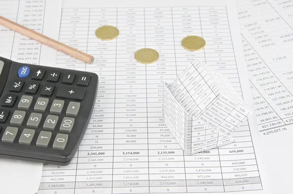 Bankruptcy of house near  gold coins and calculator with pencil — Stock Photo, Image