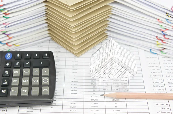 Коричневый карандаш и дом с калькулятором на финансовом счете — стоковое фото