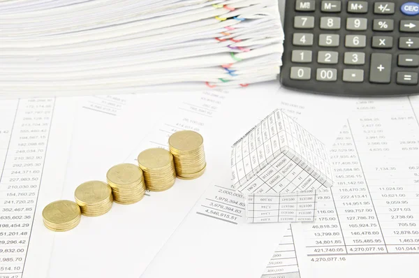 Step pile of gold coins and house on balance sheet — Stock Photo, Image