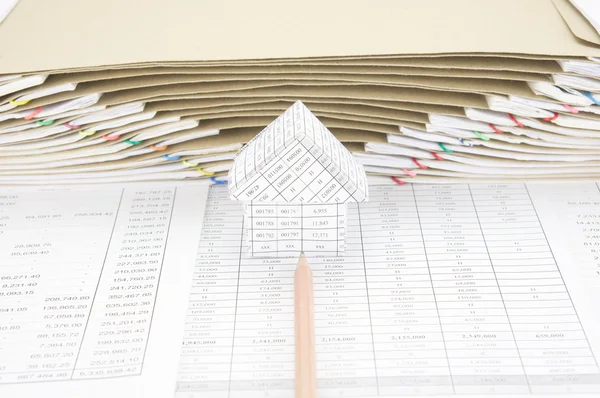 Brown pencil point to house have envelope between paperwork