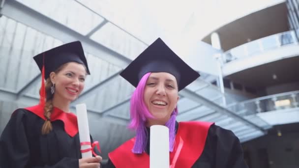 İki mutlu kız öğrenci mezuniyetini kutluyor. — Stok video