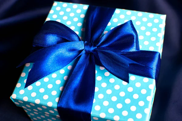 Caja de regalo azul con lazo sobre fondo azul. Tarjeta de felicitación de vacaciones. — Foto de Stock