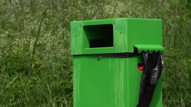 Plastik torbalı yeşil çöp kutusu.