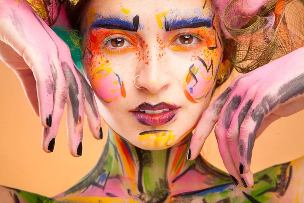 Mujer con cara de color brillante arte — Foto de Stock