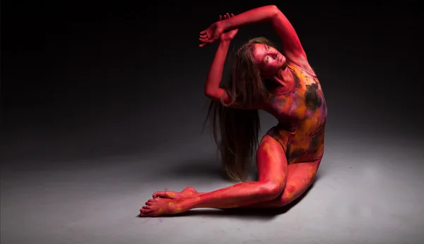 Sport woman in red posing in studio