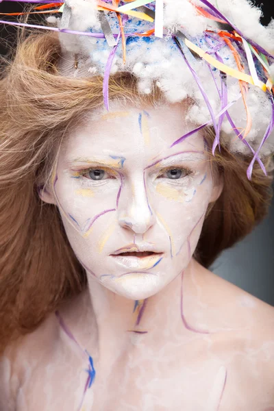 Woman with face art and creative hat — Stock Photo, Image