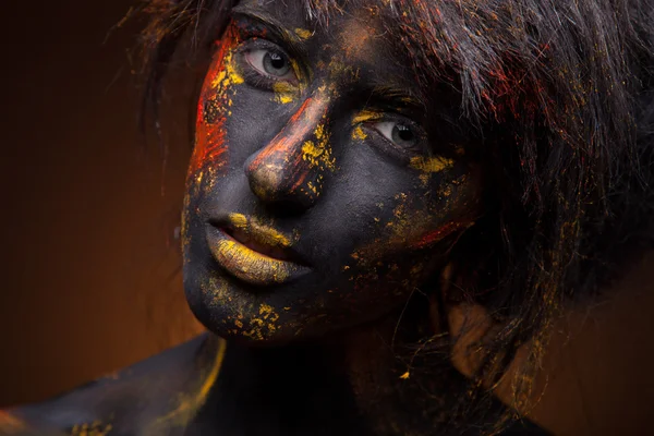 Red and yellow paint on face — Stock Photo, Image