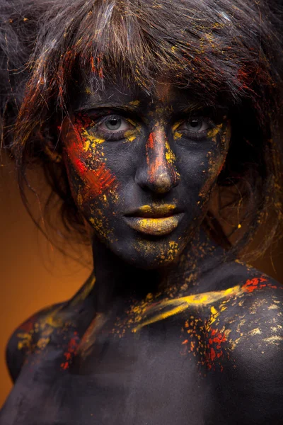 Red and yellow paint on face — Stock Photo, Image