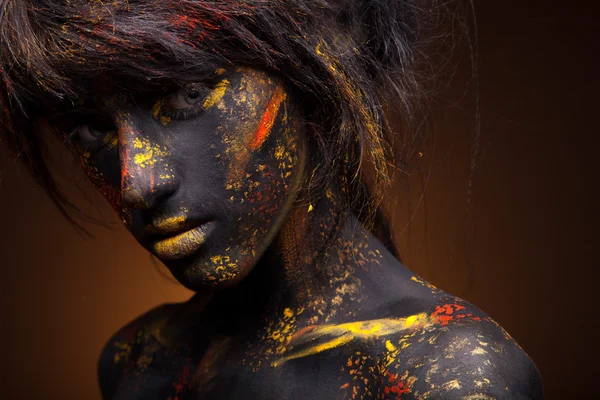 Red and yellow paint on face — Stock Photo, Image