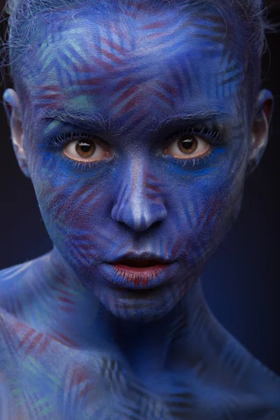 Woman with creative blue face art — Stock Photo, Image