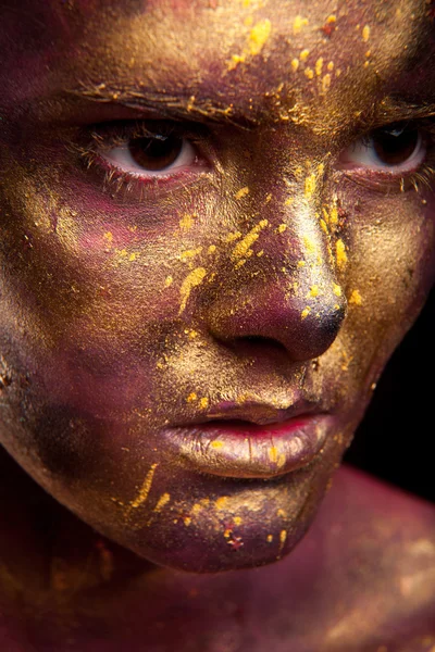 Girl with gold paint on face — Stock Photo, Image