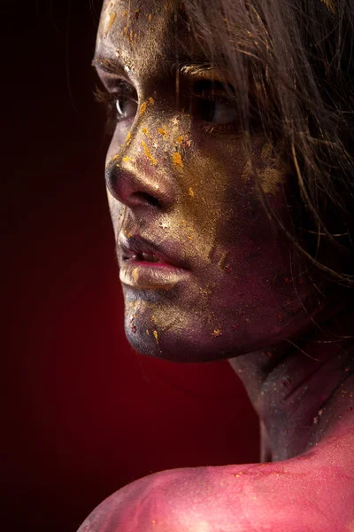 Girl with gold paint on face — Stock Photo, Image