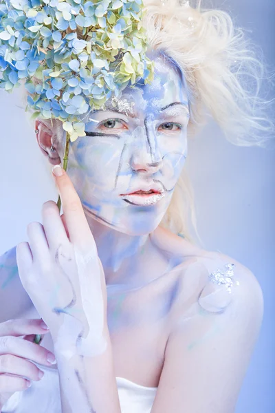 Woman with face art and flowers — Stock Photo, Image