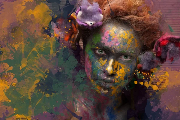 Woman in paint with flowers in hair — Stock Photo, Image