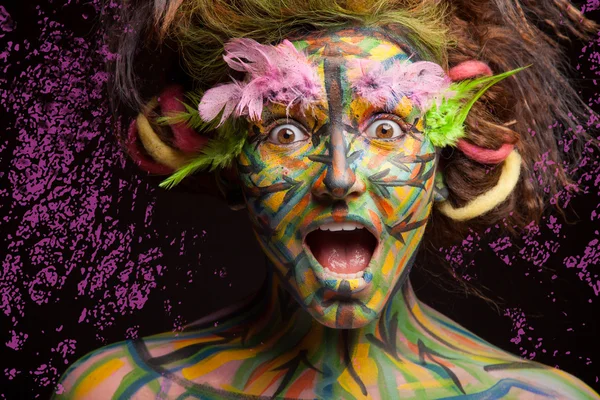 Surprised woman with face art — Stock Photo, Image