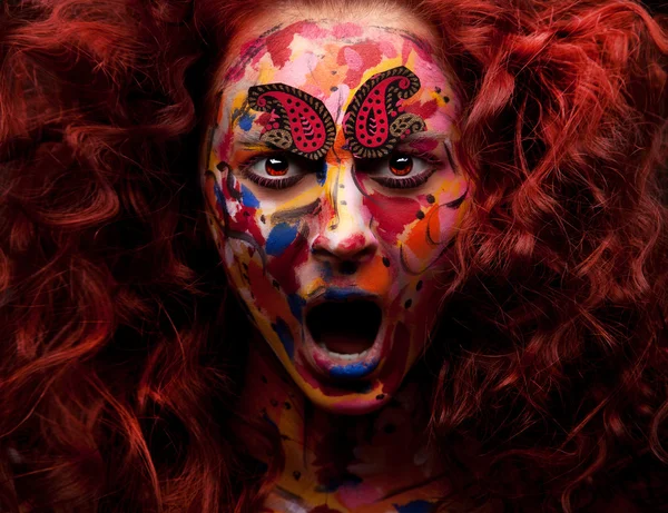 woman with face art and open mouth