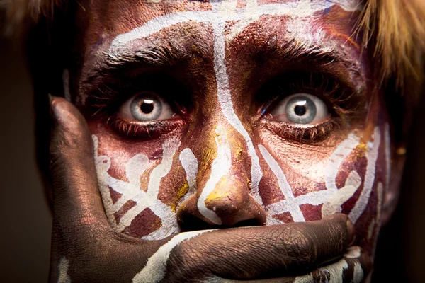 Frightened woman with tribal face — Stock Photo, Image