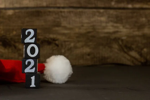 2021 year banner with santa hat and copyspace. Happy New year 2021 on wooden background — Stockfoto