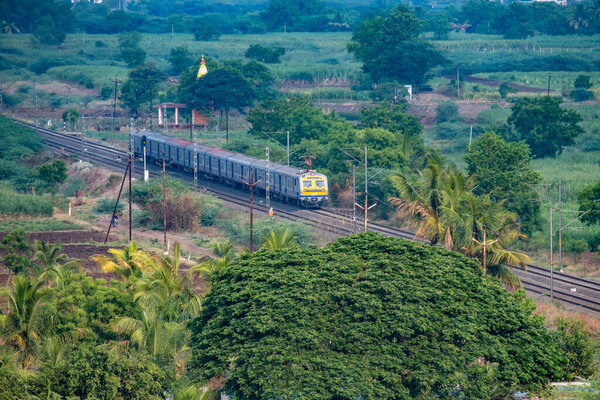 Основной электрический узел или поезд MEMU Индийских железных дорог в Урули близ Пуны Индия.