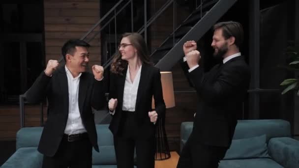 Multikulturellt team av affärsmän i formella kostymer dansar och ler efter en framgångsrik affär planering partnerskap affär verkställande möte aktieägare i företagskontor. Företag, kontrakt — Stockvideo