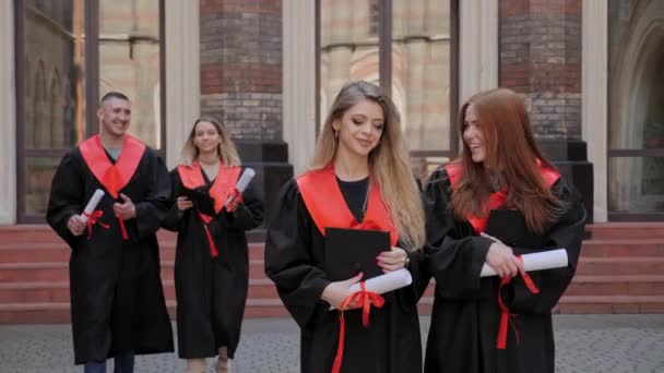 Mejores amigos alegres estudiante ir a la ceremonia de graduación de la universidad de la escuela secundaria. — Vídeos de Stock