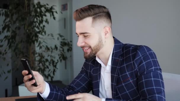 Handsome uomo d'affari tenere smartphone fa videoconferenza chiamata, parlare con un collega o un amico in remoto da videoconferenza app al telefono. Comunicazione a distanza tramite connessione internet Chat aziendale. — Video Stock