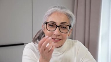 Mutlu gülümseyen büyükanne ve babaanne çocukları için laptop web kamerası görüntüsü kullanıyor.