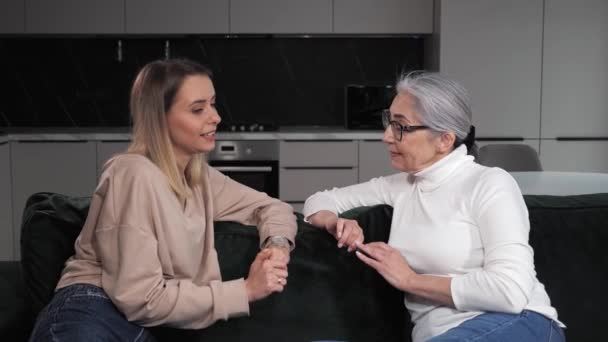 Happy old grey senior mother talking to adult daughter sharing news friendship. — Stock Footage Happy old grey senior mother talking to adult daughter sharing news friendship. Royalty Free Stock Video