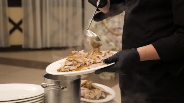 Chef giet saus op heerlijke vleesschotel in restaurant. Koken in restaurant. — Stockvideo