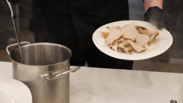 The chef pours pieces of meat with the authors sauce in a luxury restaurant. — Stock Video