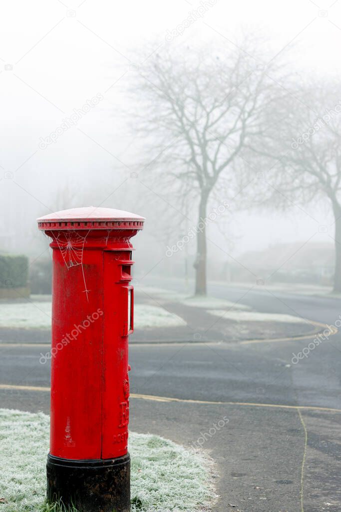 EAST GRINSTEAD, WEST SUSSEX, UK - JANUARY 10 : Hoar frost on a red pillar box in East Grinstead, West Sussex on January 10, 2021