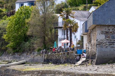 HELSTON, CORNWALL, UK - MAY 14 : People enjoying dining out at the Shipwright Arms in Helston, Cornwall on May 14, 2021. Unidentified people clipart