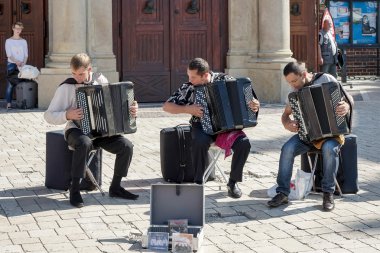 Three men playing accordians in Krakow clipart