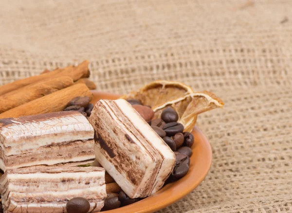 Sweets, cinnamon, nuts and coffee beans — Stock Photo, Image