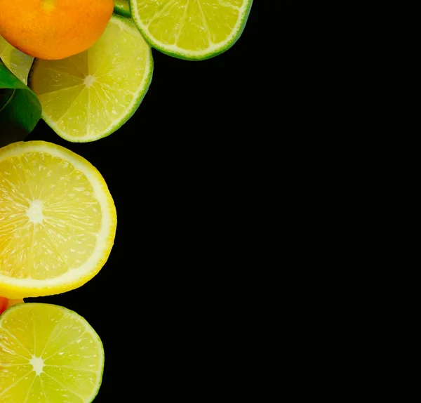 Stacks of sliced fruit isolated on black — Stock fotografie