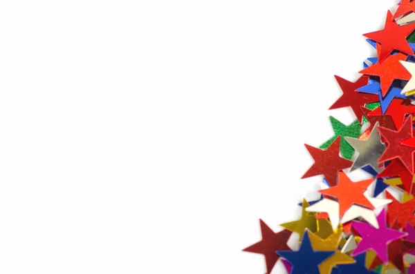 Kerstdecoratie van gekleurde confetti sterren — Stockfoto
