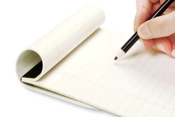 Pencil in hand writing on the notebook — Stock Photo, Image
