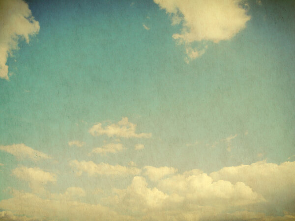 White clouds in blue sky in grunge and retro style